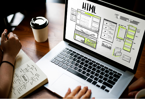 Laptop showing an HTML wireframe sketch